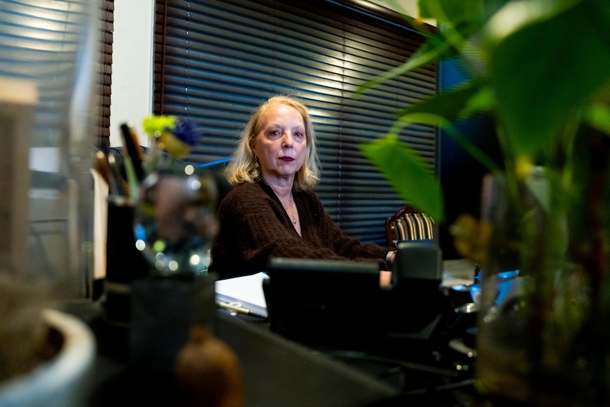 A woman sitting at a desk.
