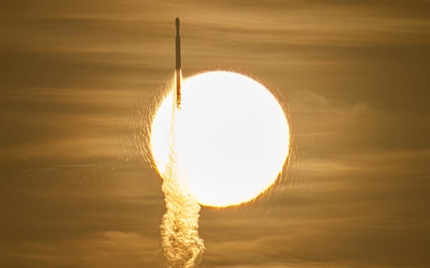 A SpaceX Falcon Heavy rocket with NASA’s Nancy Grace Roman Telescope on board is seen transiting the sun during launch from Launch Complex 39A.