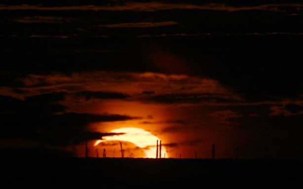 The moon passes in front of the sun as it sets during a partial solar eclipse in Saint Petersburg on August 12, 2026. (Photo by Olga MALTSEVA / AFP)