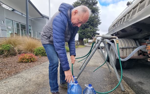 Colin Young fills a water bottle.