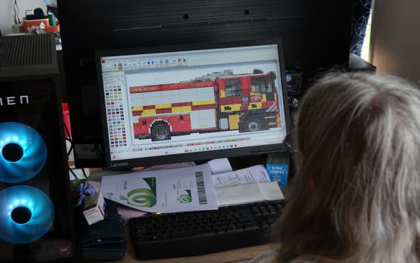 Edith Gilligan works on a knitting pattern based on a photo of a Dargaville fire truck.