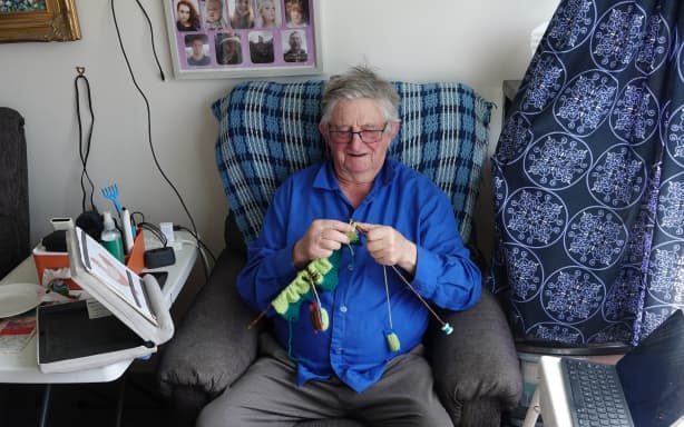 Mike Gilligan gets started on yet another baby blanket.
