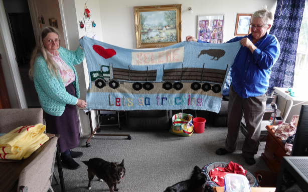 Edith and Mike Gilligan with one of his bigger blankets, knitted for a granddaughter.