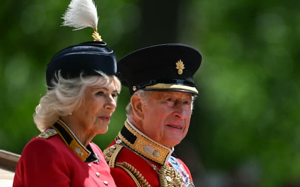 Britain's King Charles III and Britain's Queen Camilla make their way back to Buckingham Palace from Horse Guards Parade during the King's Birthday Parade "Trooping the Colour" in London on June 13, 2026. (Photo by JUSTIN TALLIS / AFP)