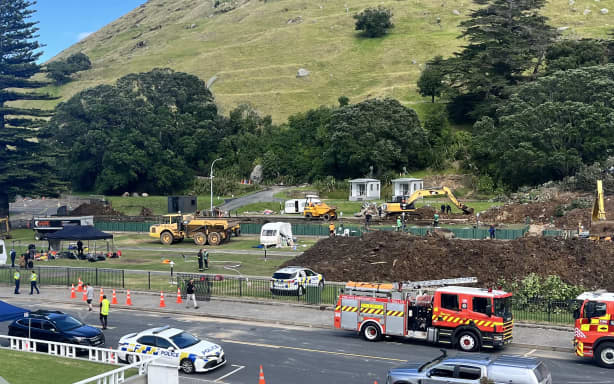 A search continues by local emergency services for missing people following a landslide at Mount Maunganui in Tauranga on January 23, 2026. Rescuers dug into deep mud searching for at least six missing people on January 23, after a landslide from an extinct volcano crashed into a popular campsite in northern New Zealand. (Photo by Ben STRANG / AFP)