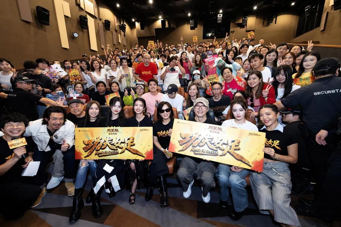 (Front row, third from right) Stephen Chow with his cast and fans at a Kung Fu Soccer screening in Hong Kong on Aug 8.
