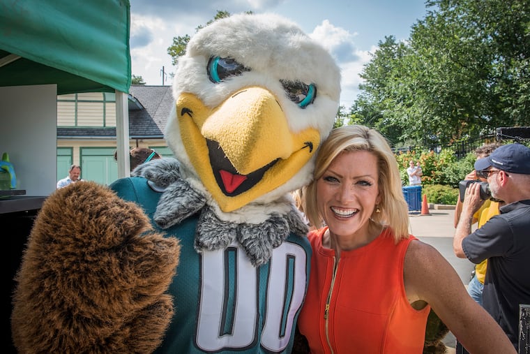Cecily Tynan, seen here with Eagles mascot Swoop, is retiring after more than 30 years at 6abc.