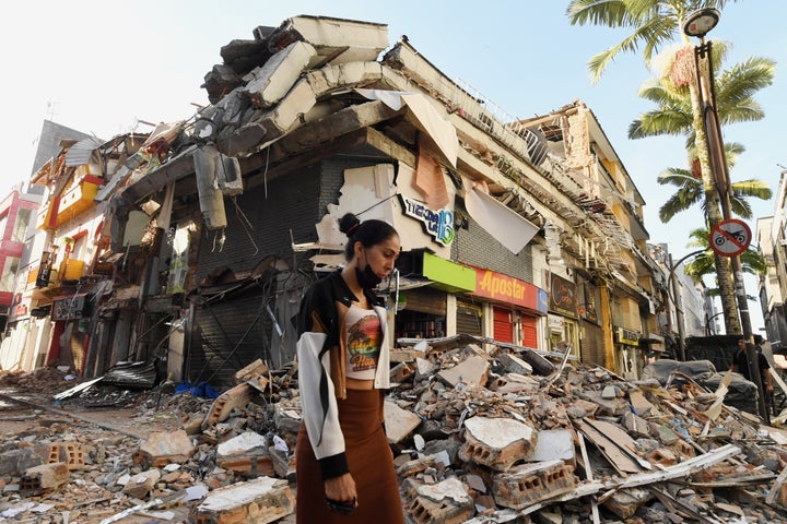 A woman walks past the rubble of a collapsed building after an earthquake in Pereira, Colombia, on Aug. 11, 2026.