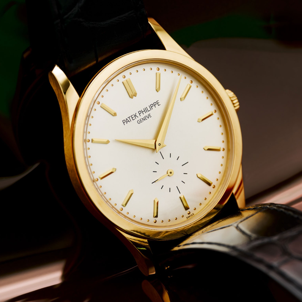 elegant gold wristwatch with leather strap and minimalist design.