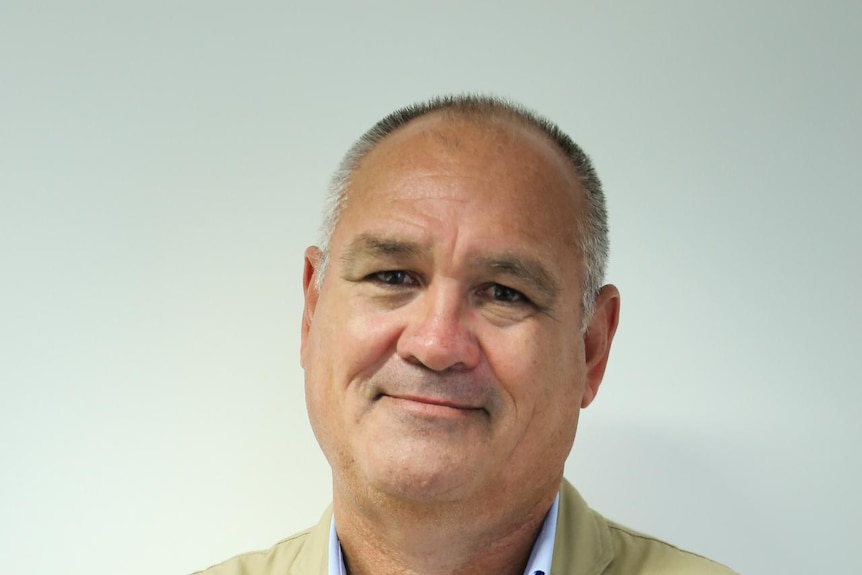 A man smiles at the camera.
