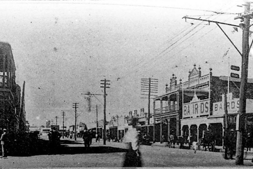 A black-and-white old photo of dust over a city.
