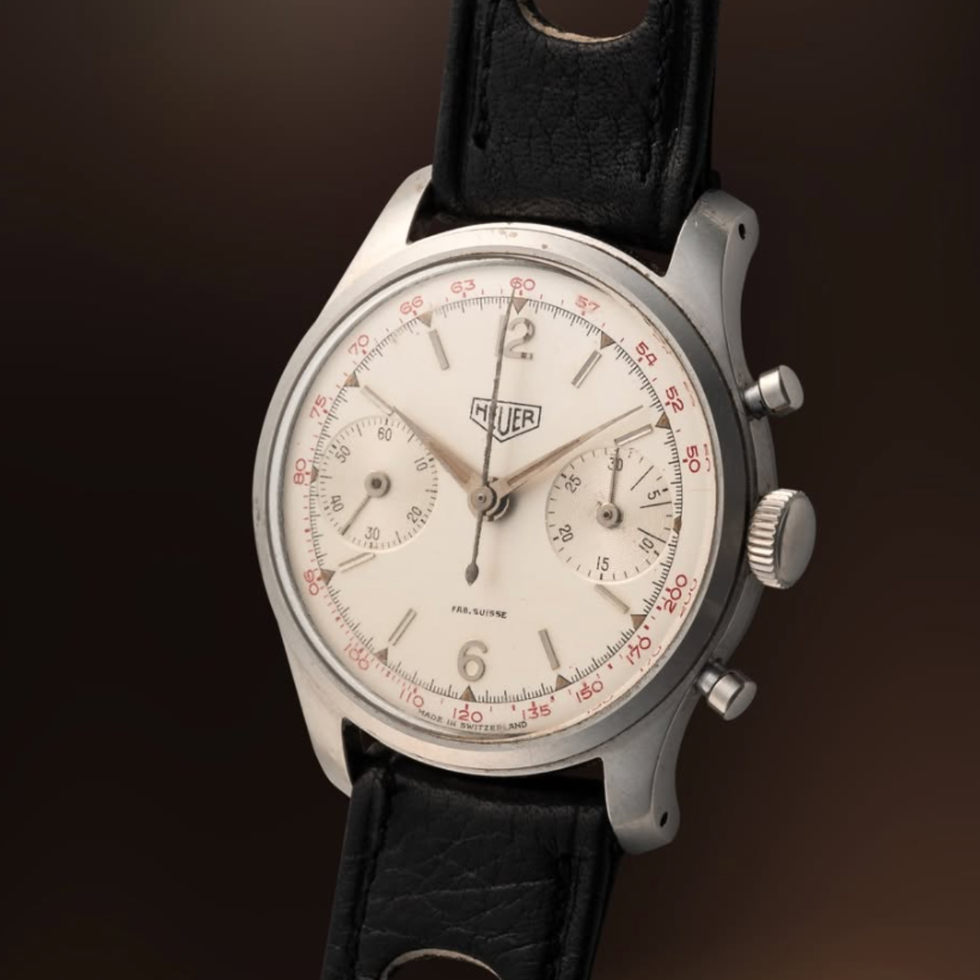 vintage heuer chronograph watch with black leather strap.
