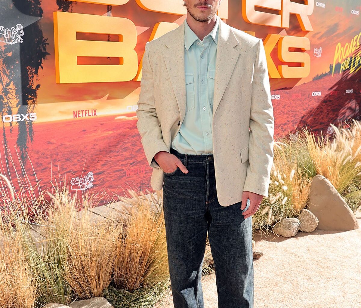 Drew Starkey wears Dior with an off-white blazer, pale blue shirt and dark jeans at the ‘Outer Banks’ Season 5 fan farewell in Los Angeles.