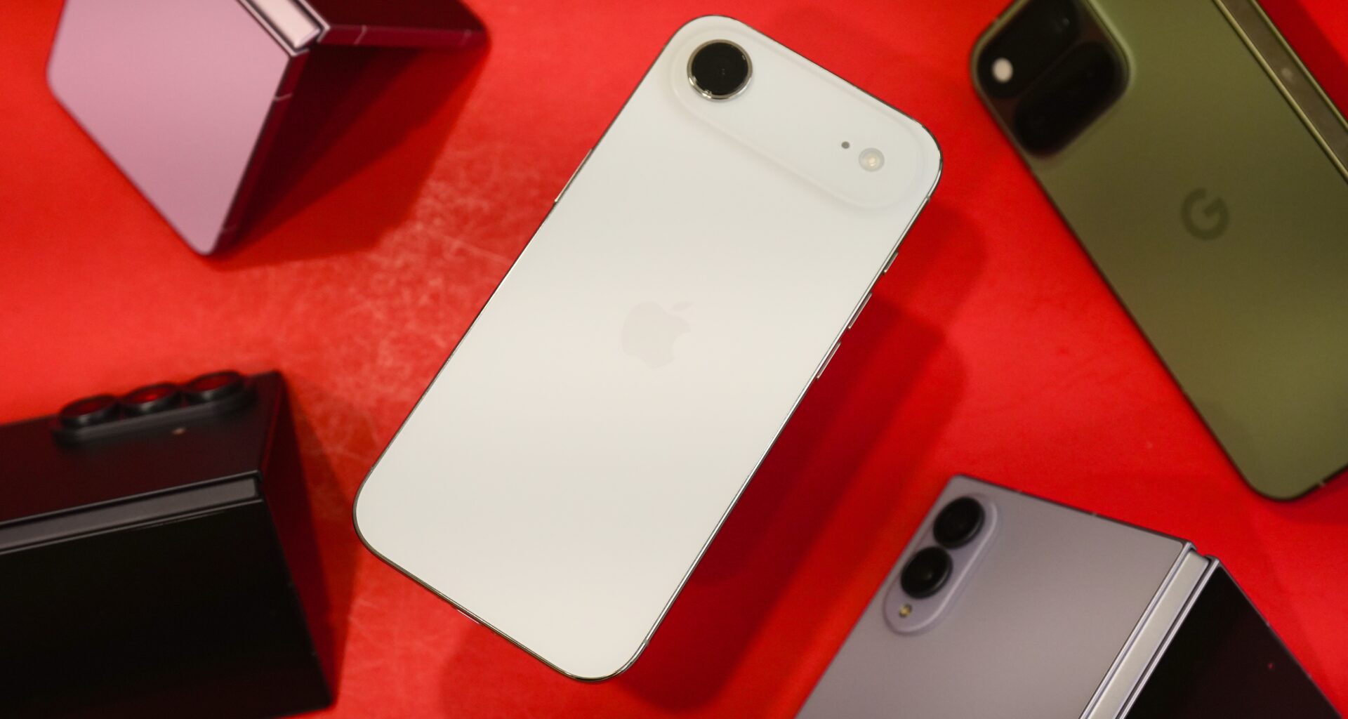 The iPhone Air surrounded by various Android foldable phones.