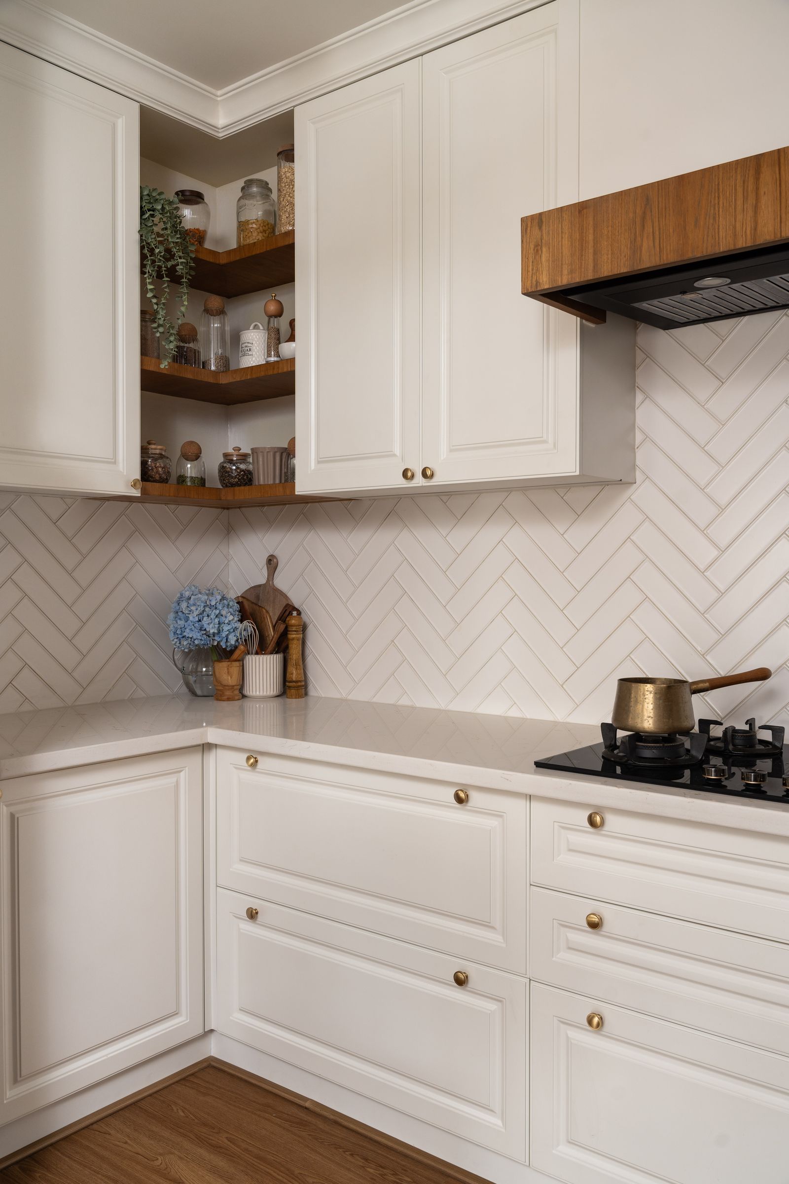 Image may contain Indoors Interior Design Kitchen Shelf Cooktop Cabinet Furniture Sink Sink Faucet and Plant