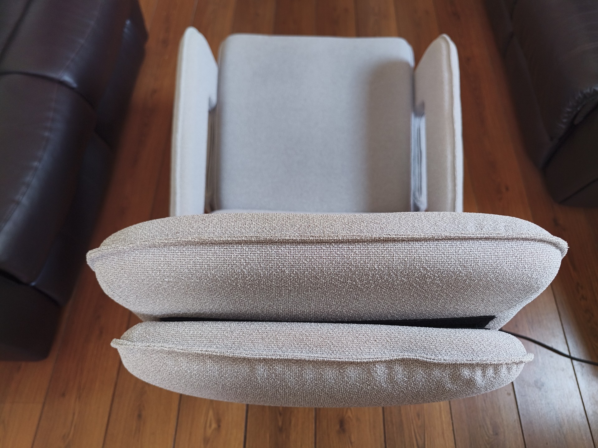 Overhead close-up of the chair's headrest and armrests, showing the texture of the boucl&eacute;-style fabric.