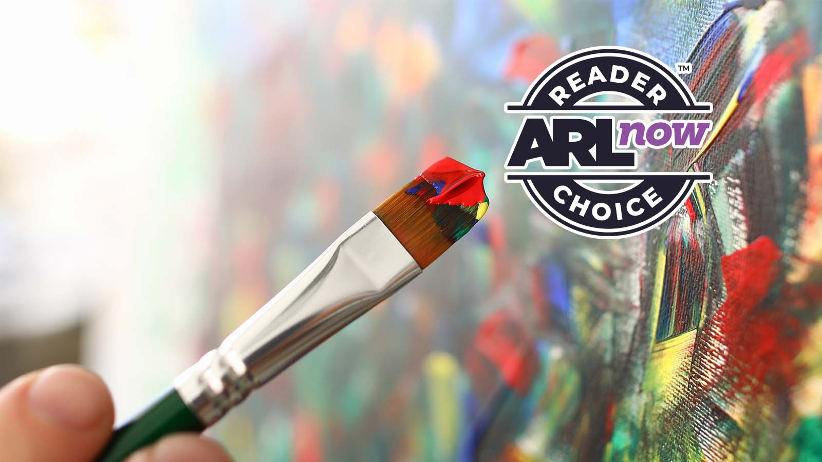 Jul 31, 2026_ Places to Take an Art Class in Arlington | ARLnow Close-up of a paintbrush with red, yellow and blue paint, painting a vibrant canvas, with a circular 'Reader’s Choice AR Now' badge in the upper right.