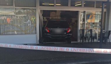 Car ploughs through Red Beach shopping block, three people treated for injuries