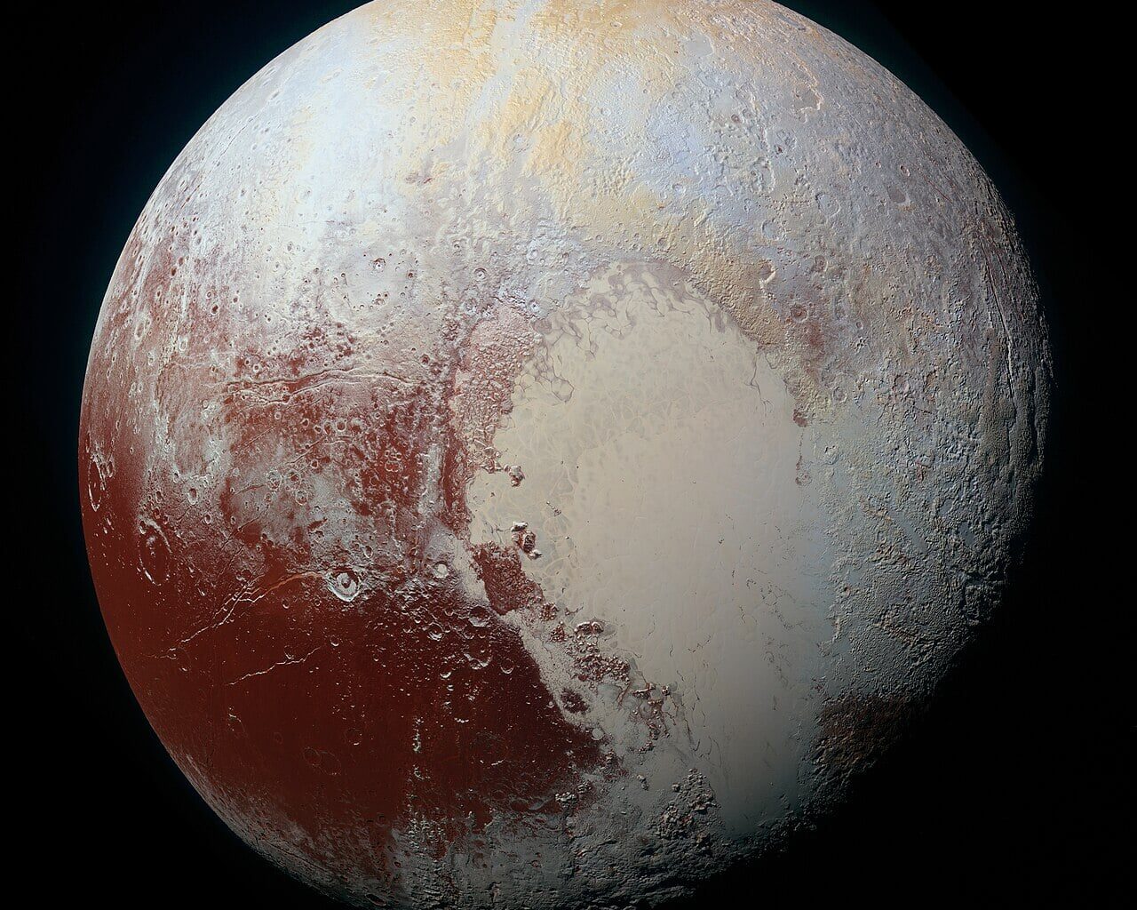 Pluto as seen by New Horizons during its 2015 flyby. Sputnik Planitia is a heart-shaped region that appears to be resurfaced by upwelling liquid nitrogen from below. That action creates what look like convection cells outlined by darker lines that could be flow channels. Credit: NASA/JHU/APL/New Horizons mission