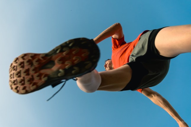 Athletic man running outdoors on a bright day, showing an active lifestyle