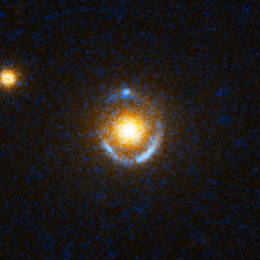 The blue rings are distant galaxies smeared into circles by the mass of the reddish elliptical galaxies in front of them (Credit : NASA/ESA/SLACS Survey Team: A. Bolton (Harvard/Smithsonian), S. Burles (MIT), L. Koopmans (Kapteyn), T. Treu (UCSB), L. Moustakas (JPL/Caltech))