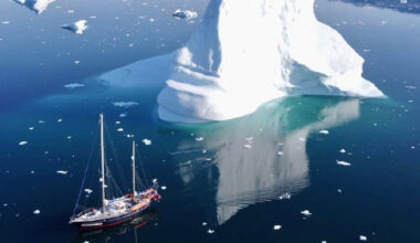 sailboat near iceberg