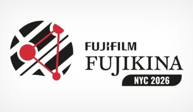 A logo for FUJIFILM FUJIKINA NYC 2026 featuring a circular graphic of black diagonal stripes overlaid with a red triangular network.