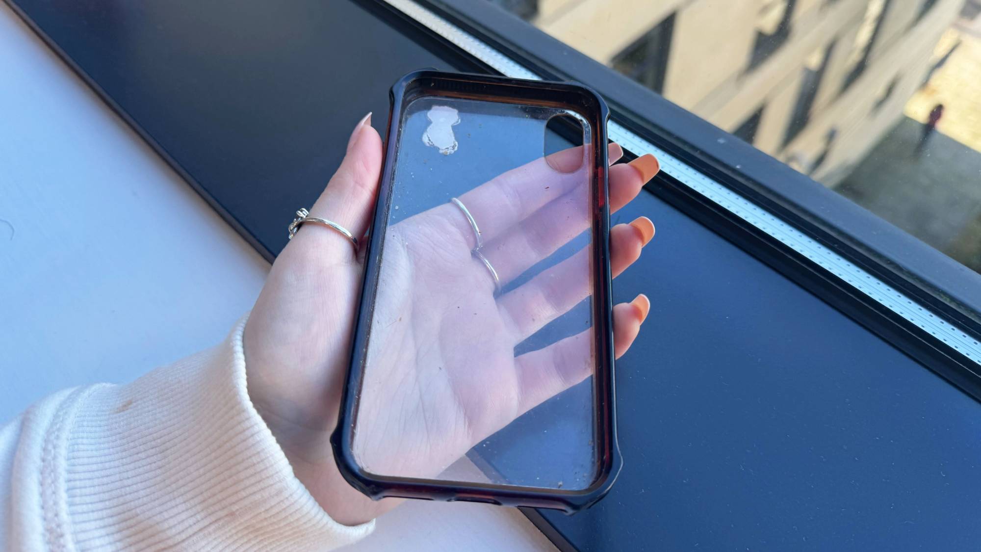Person holding clear phone case