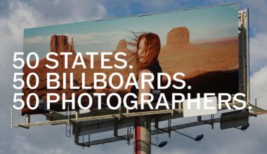 A large outdoor billboard against a cloudy sky features a woman with windblown hair standing in front of a desert landscape, with the text "50 STATES. 50 BILLBOARDS. 50 PHOTOGRAPHERS." overlaid.
