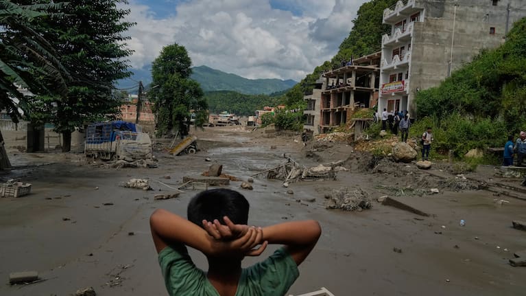 A boy looks at the devastation caused by flash flooding along the Trishuli River in Nepal's Nuwakot district