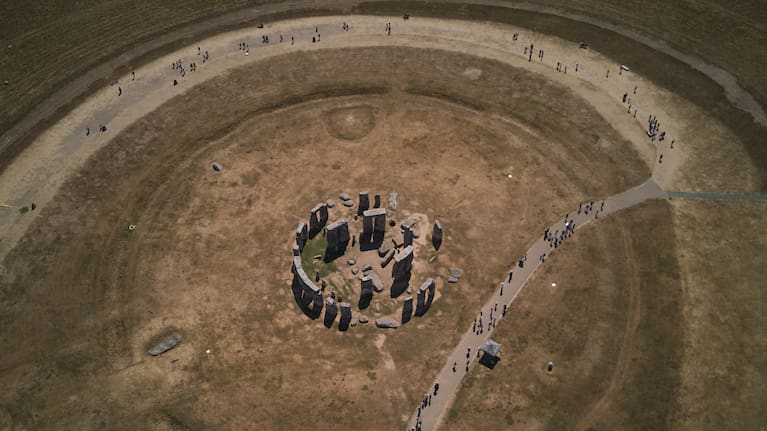 A general view of the ancient stone circle Stonehenge amid dried grass in Wiltshire, England.