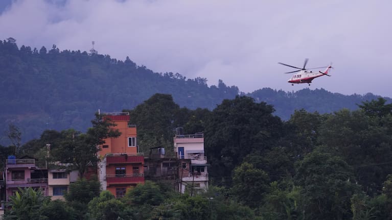 A government helicopter conducts a rescue mission amidst the devastation left by flash flooding in Nepal's Nuwakot district, Thursday, August 27, 2026.