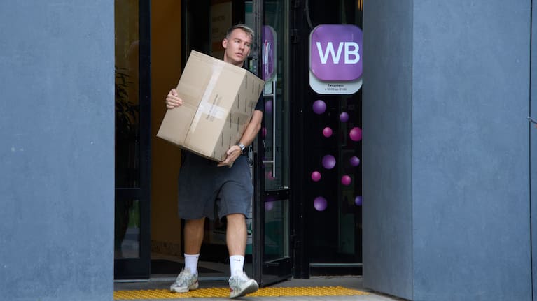 A man carrying a package leaves an outlet of Russia's major online retailer Wildberries in Moscow.