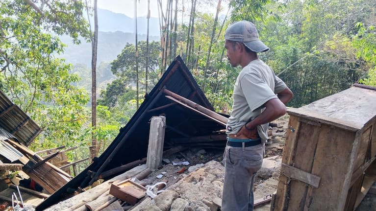 A man examines the damage to a building following an earthquake in East Manggarai, East Nusa Tenggara province, Indonesia, Saturday, Aug. 15, 2026.