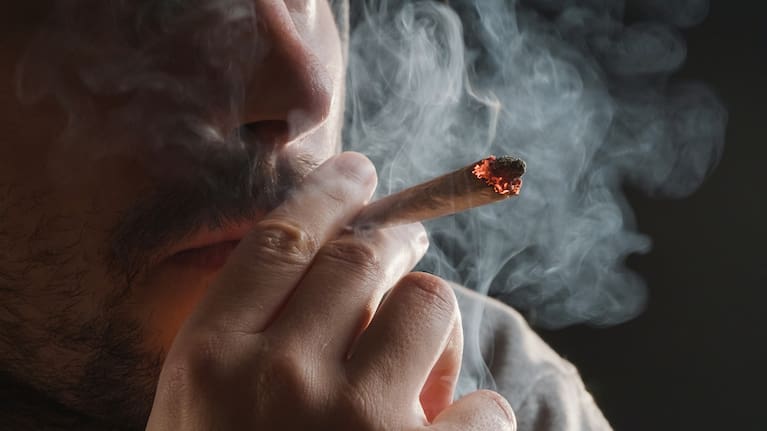 A man smokes a cannabis joint.