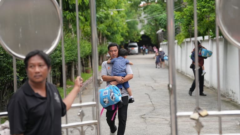 A parent leaves after picking his child after a shooting at the Debsirin Nonthaburi School in Thailand's Nonthaburi province, Friday, Aug. 7, 2026