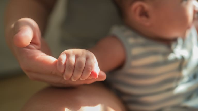 A parent plays with their baby (file image).