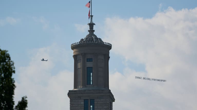 A plane flies over Nashville, Tenn., towing a banner reading “change.org/DollyPartonAirport” as part of an effort to rename the airport after Dolly Parton, Friday, August 28, 2026.
