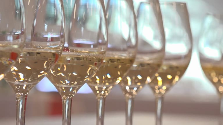 A row of wine glasses with white wine (file image).