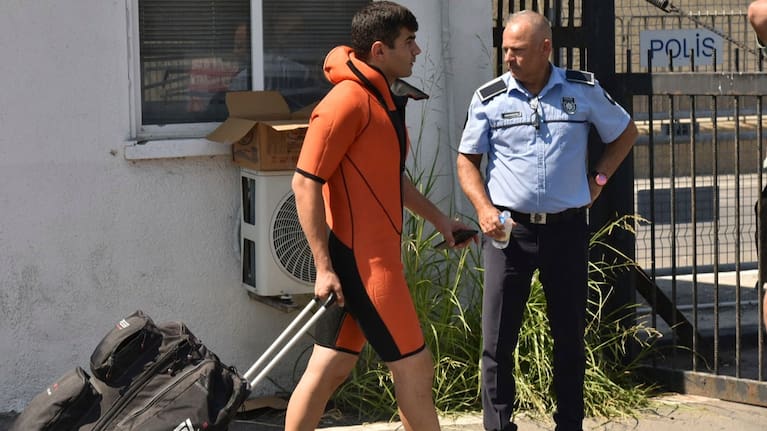 A survivor of a catamaran-style ferry which was capsized off the coast of northern Cyprus, arrives at the port of Kyrenia.