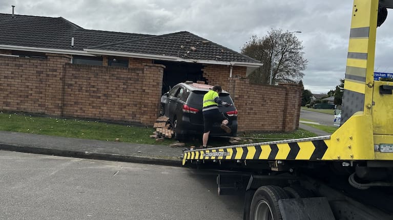 A tow truck removes a car from a property in Awapuni, Palmerston North.