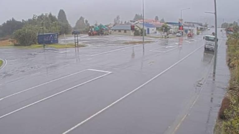 A wet looking State Highway 6, into Fox Glacier township.