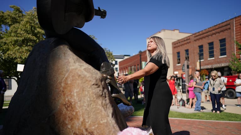 A woman stands before a statue of Dolly Parton in Sevierville, Tennessee, Tuesday, August 25, 2026.