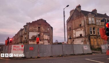 Derelict buildings in Pollokshields, with boarding around it