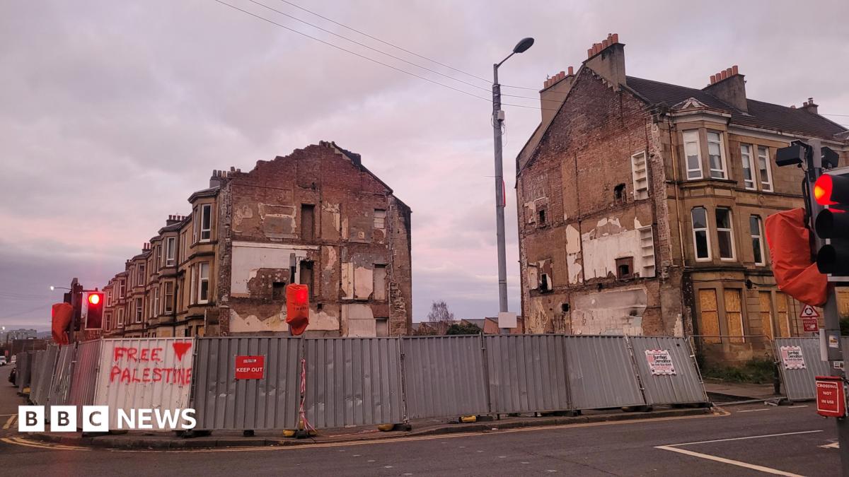 Derelict buildings in Pollokshields, with boarding around it