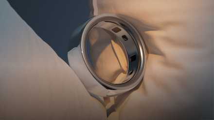 An Oura Ring on a pillow.