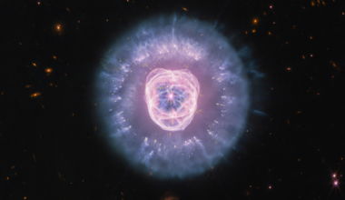 A purple bright center is surrounded by darker purple and blue bright light.