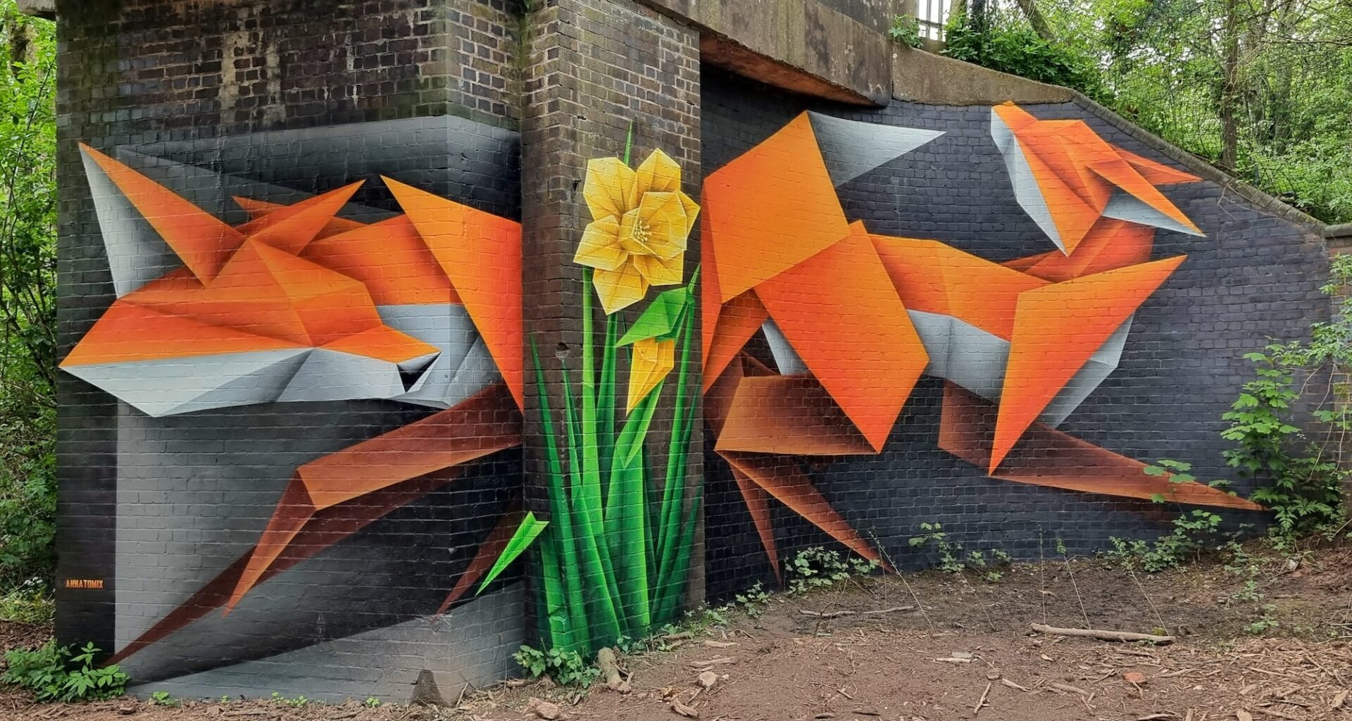 a geometric fox mural by Annatomix under a bridge, with a daffodil painting on a column
