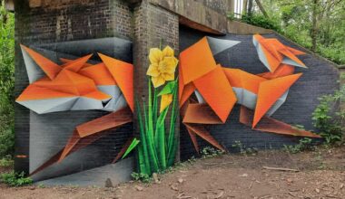 a geometric fox mural by Annatomix under a bridge, with a daffodil painting on a column