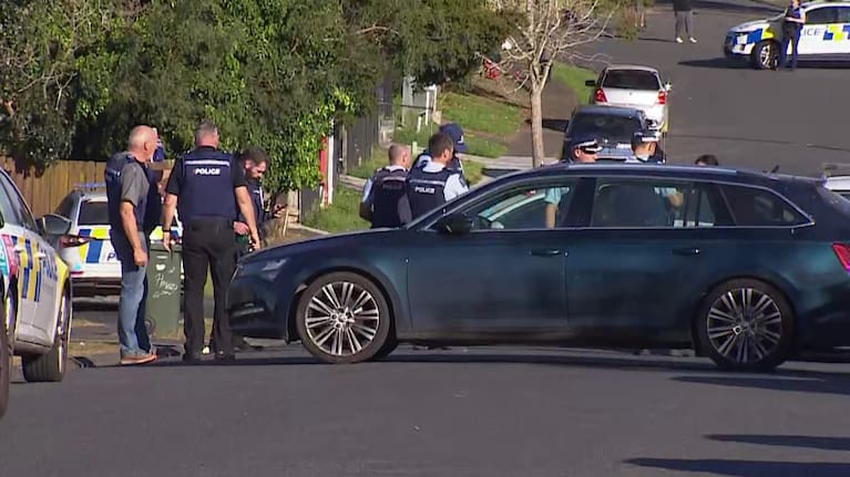 Armed police cordoned off the street following a fatal incident.
